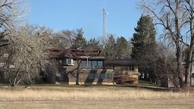 ARVADA COLORADO-2015: A Old House Is Surrounded By Many Trees On A Beautiful Day