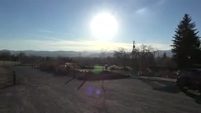 ARVADA COLORADO-2015: View of Bright Noonday Sun in Blue Sky with Low Lying White Clouds