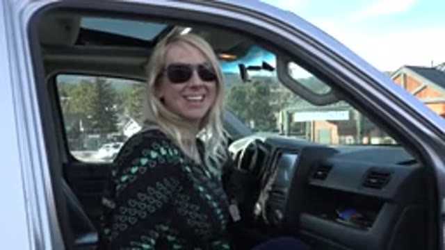 NEDERLAND COLORADO-2015: Girl in Green and Black Top Says Hello From Truck
