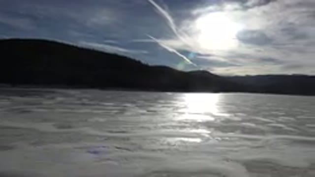 NEDERLAND COLORADO-2015: A Panning Shot Of A Frozen Lake In Front Of Some Mountains