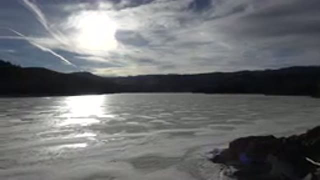 NEDERLAND COLORADO-2015: Frozen Body Of Water With A Mountainside Off In The Distance