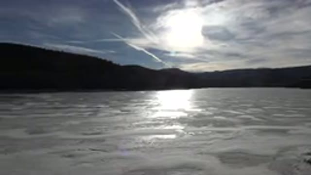 NEDERLAND COLORADO-2015: Frozen Lake In The Woods With Trees On The Skyline And