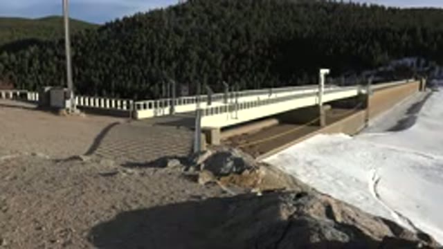 NEDERLAND COLORADO-2015: Bridge Connecting Roads On A Mountain Above A Frozen River