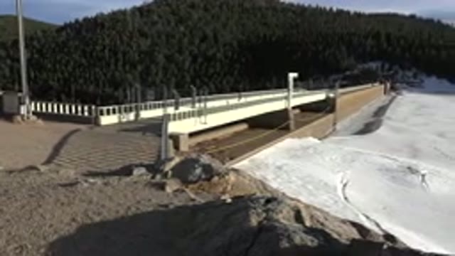 NEDERLAND COLORADO-2015: White Long Bridge Extends Over A Frozen Lake