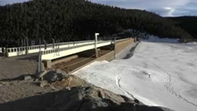 NEDERLAND COLORADO-2015: Bridge In The Snowy Mountains Leading Into Huge Green Forest