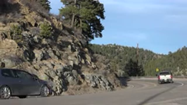 NEDERLAND COLORADO-2015: Green Trees Blue Sky And Gray Rocks On A Sunny Day