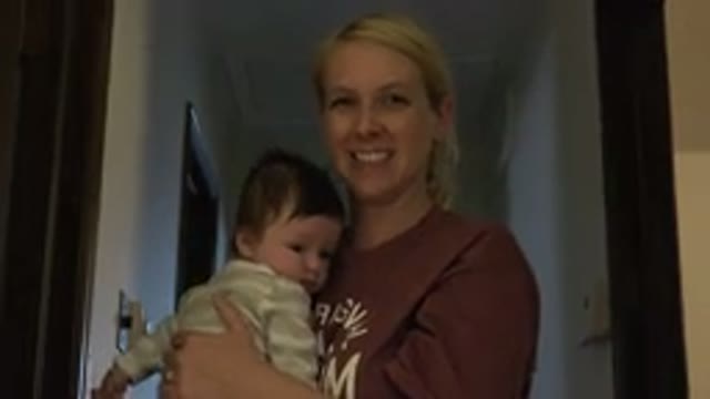WESTMINSTER COLORADO-2015: Woman Holding Newborn Waves To Camera Smiles And Says