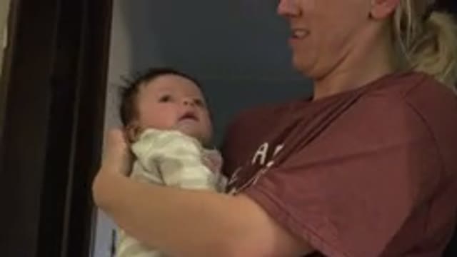 WESTMINSTER COLORADO-2015: A Blonde Mother Smiling While Holding Her Baby Who Is