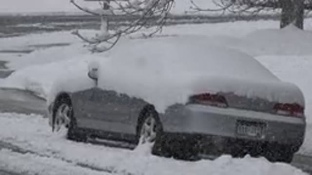 WESTMINSTER COLORADO-2015: Gray Snow Covered Car Parked On Street On A Cloudy