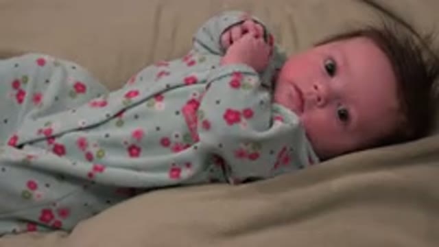 WESTMINSTER COLORADO-2015: Young Infant Lays On Its Back Looking Around The Room