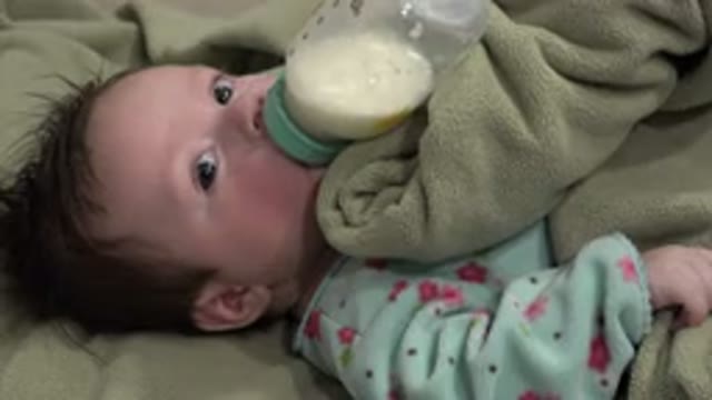 WESTMINSTER COLORADO-2015: A Baby Is Drinking Milk From Bottle While Sleeping On