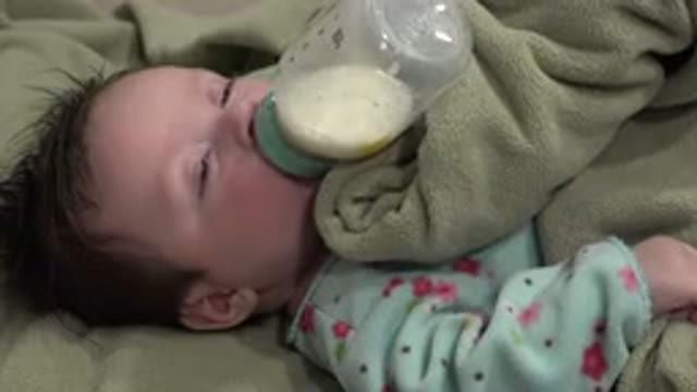 WESTMINSTER COLORADO-2015: Cute Sleepy Baby Drinking Milk From Bottle