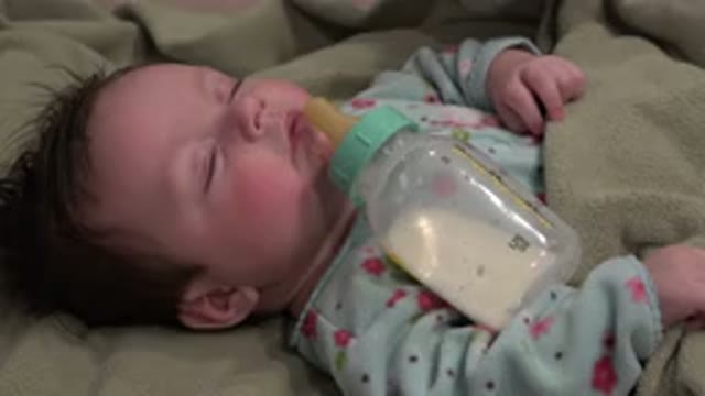 WESTMINSTER COLORADO-2015: Baby in Blue Pajamas Sleeping with Bottle of Milk