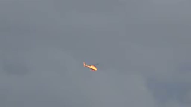 WESTMINSTER COLORADO-2015: Red And White Helicopter Flying On A Cloudy Day