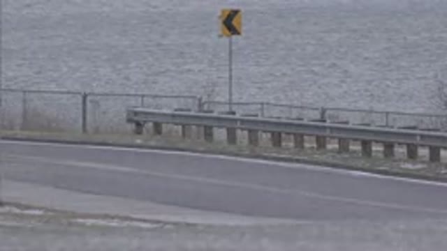 WESTMINSTER COLORADO-2015: Oncoming Traffic Around A Bend With Roadside Near Water