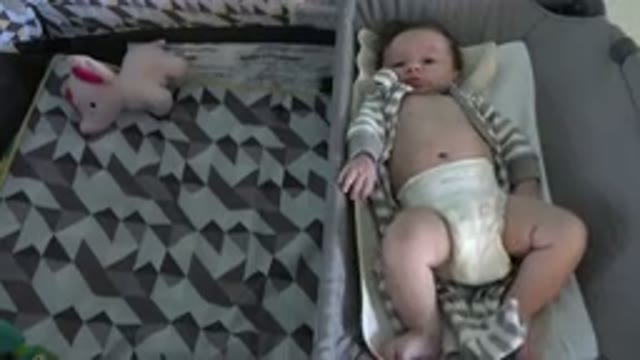 WESTMINSTER COLORADO-2015: Baby Wearing Tan and White Sleeper Lies in White Bassinet