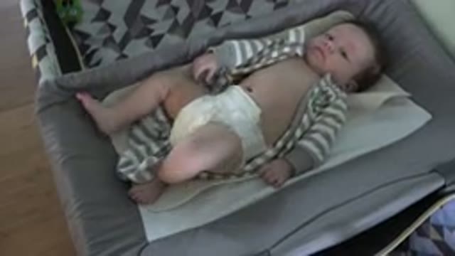 WESTMINSTER COLORADO-2015: Baby Lies On A Tan Blanket Looking At Camera