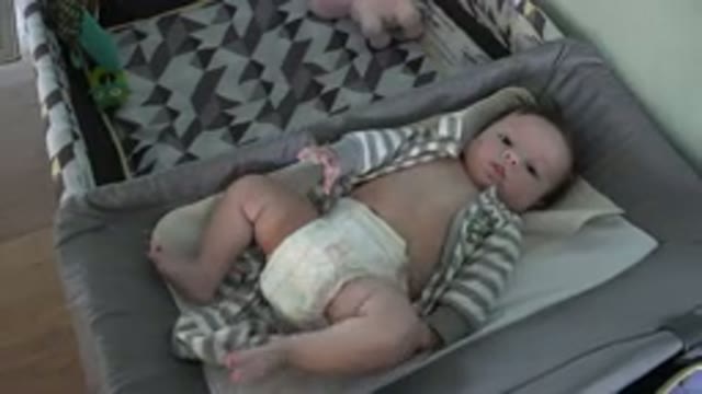 WESTMINSTER COLORADO-2015: Baby Wearing Gray and White Sleeper Lies in Tan Bassinet