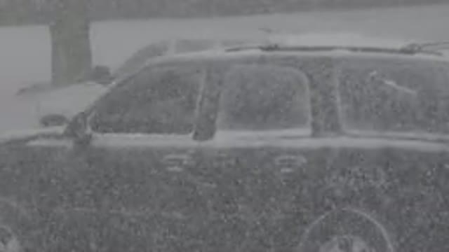 WESTMINSTER COLORADO-2015: Black Jeep Turning on Snowy Road with White Car Red Rear Lights