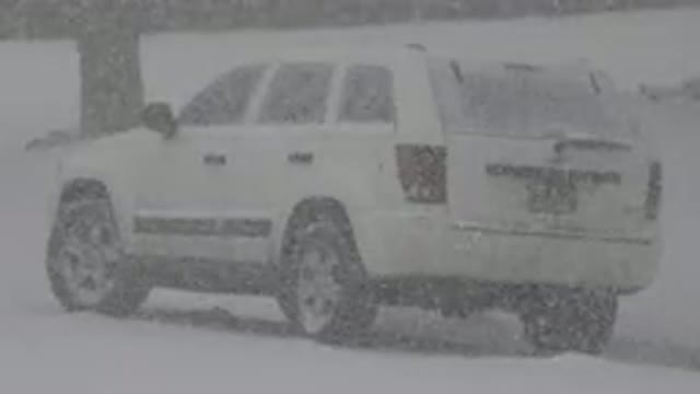 WESTMINSTER COLORADO-2015: White SUV Stranded By Tree As Car Passes By In Snowstorm