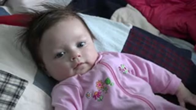 WESTMINSTER COLORADO-2015: A Little Baby With Blond Hair Blue Eyes Wearing A Pink Romper