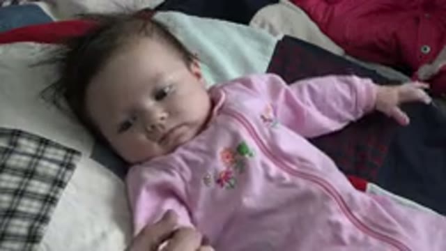 WESTMINSTER COLORADO-2015: Baby Lies On A Patchwork Quilt Looking At The Camera