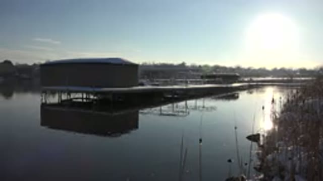 WESTMINSTER COLORADO-2015: Tan Building On White Platform Over Calm Water On A Sunny Day
