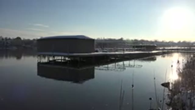 WESTMINSTER COLORADO-2015: A House In The Middle Of Pond With Sun Rays Reflecting