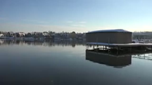 WESTMINSTER COLORADO-2015: Tan Building On White Platform Over Calm Water On A Sunny Day