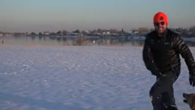 WESTMINSTER COLORADO-2015: A Man In Black Playing In The Snow With His German Shepherd