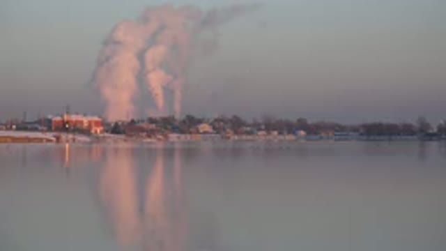 WESTMINSTER COLORADO-2015: Factory Releasing Fumes Into Air Close To A Lake In A