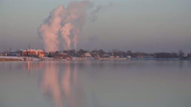 WESTMINSTER COLORADO-2015: Zoomed Out View Of A Town On The Water With Lot Of Smoke