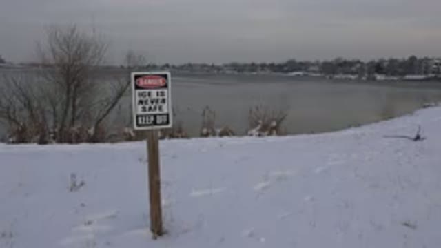 WESTMINSTER COLORADO-2015: Black White And Red Danger Sign Near Frozen Pond On A