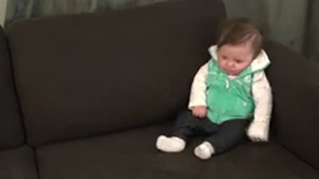 WESTMINSTER COLORADO-2015: Baby Wearing Green and White Vest Sits on Brown Sofa