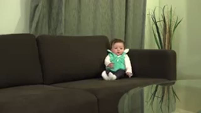 WESTMINSTER COLORADO-2015: Infant Sits Up Against Corner of Brown Couch