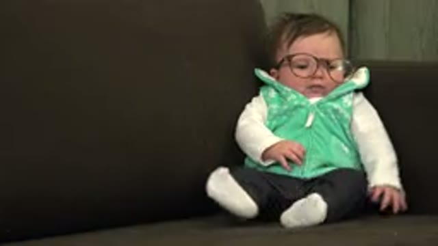 WESTMINSTER COLORADO-2015: A Baby Sitting On A Couch Dressed In White And Green