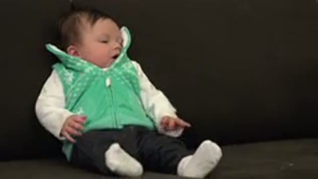 WESTMINSTER COLORADO-2015: A Baby With Green Clothes And Black Hair Crying On