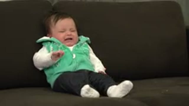 WESTMINSTER COLORADO-2015: A Baby Wearing White T-Shirt and Black Pants Cries on a Sofa