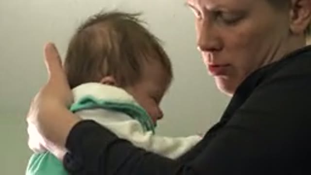 WESTMINSTER COLORADO-2015: Woman Wearing Black Shirt Holds Tiny Infant Wearing White