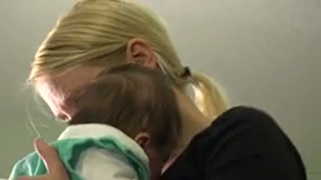 WESTMINSTER COLORADO-2015: A Woman Carrying Her Baby in Her Arms and Caring for Him