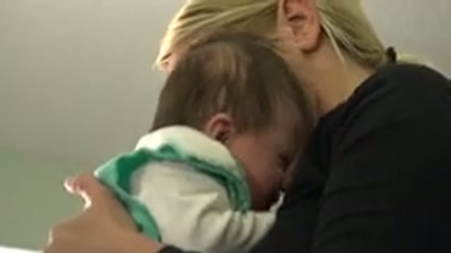 WESTMINSTER COLORADO-2015: Blonde Woman Bouncing and Comforting a Baby