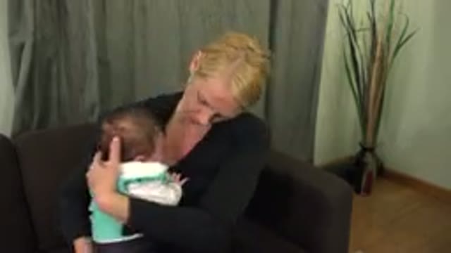 WESTMINSTER COLORADO-2015: Mother in Black Top Holding and Caring for a Young Child