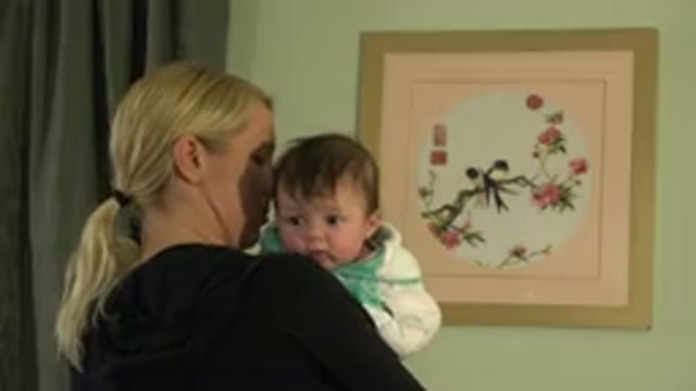 WESTMINSTER COLORADO-2015: Blonde Woman With A Ponytail Holding A Baby Near A