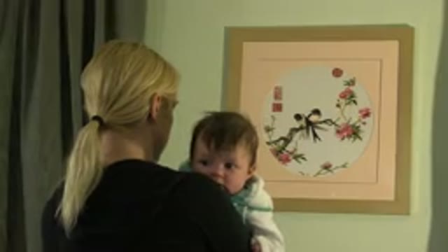 WESTMINSTER COLORADO-2015: Woman Holding Her Baby In A Room
