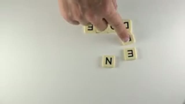 WESTMINSTER COLORADO-2015: Hand Arranges Scrabble Letter Tiles To Create Word