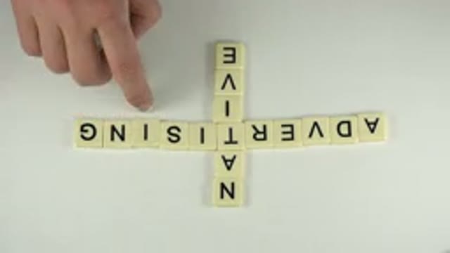 WESTMINSTER COLORADO-2015: Hand Lines Up Scrabble Letter Tiles to Spell Words