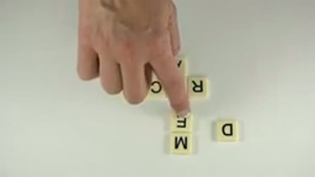 WESTMINSTER COLORADO-2015: A White Hand Moves Scrabble Letters To Produce Two