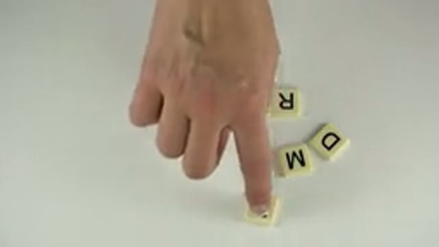 WESTMINSTER COLORADO-2015: Person Arranging Letter Tiles to Form Words