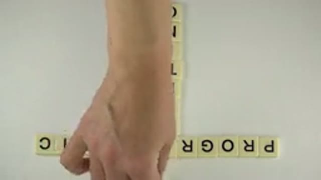 WESTMINSTER COLORADO-2015: Human Being Repairing Misplaced Letter Tile From The Scrabble Game