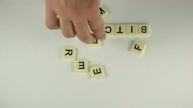 WESTMINSTER COLORADO-2015: A Hand Placing Scrabble Tiles On A Table To Spell